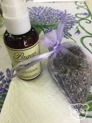 Lavender lotion and dried lavender satchel on a napkin.