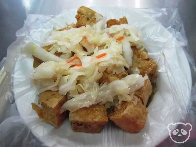 Plate of fried stinky tofu and pickles.