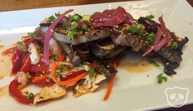 Grilled beef short ribs with stir fried bell peppers and onions. 
