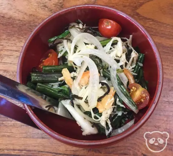 Fiddle fern salad with tomatoes, seaweed, and squid slices. 