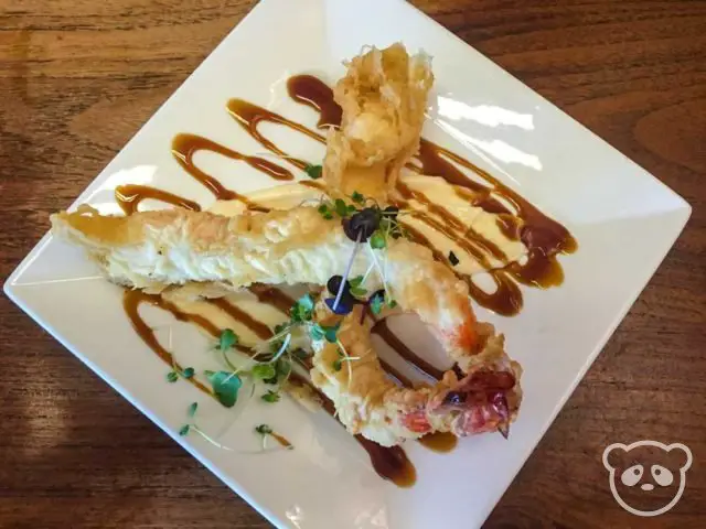 Two large fried shrimp with teriyaki sauce. 